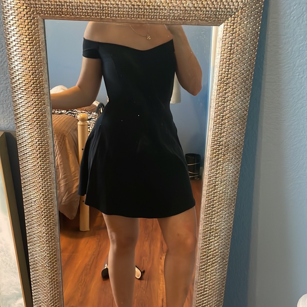 Black off the shoulder dress.